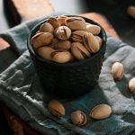 Bowl full of pistachios with salt.