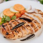 Grilled chicken pieces with tomatoes, carrots, fried peppers, red onion, cucumber,  and mint.