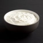 Homemade Ranch Dressing in a Bowl on a black background, side view.
